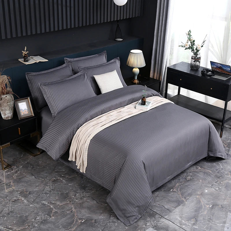 Gray bedding set on a bed in a modern bedroom with decor elements.