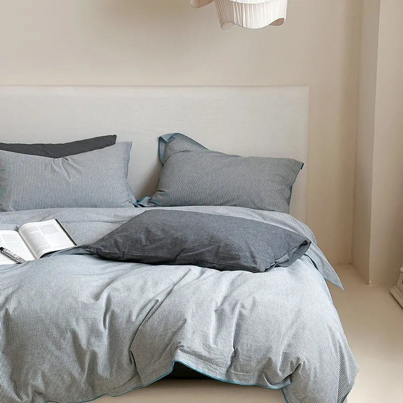 Gray textured bedding set on a bed with a neutral background