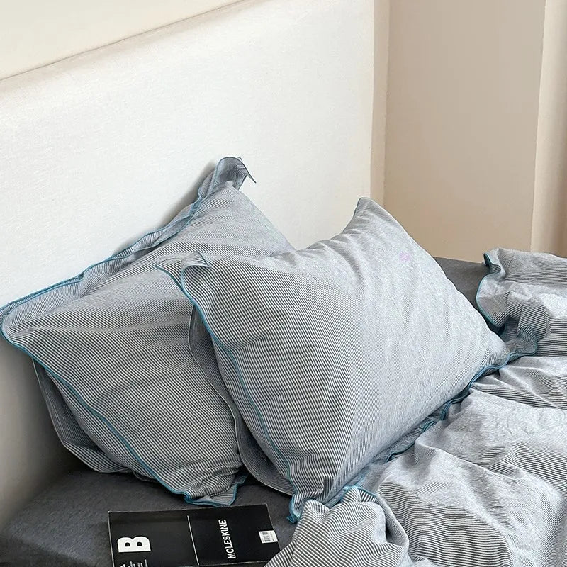 Gray textured pillows with blue trim bedding set