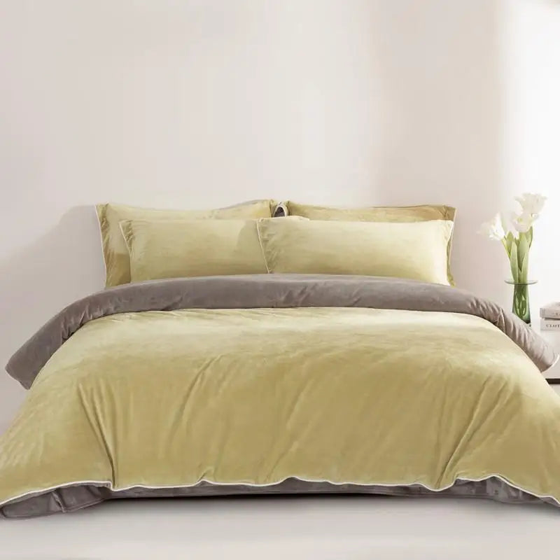 Green and gray bedding set on a bed with a white wall background