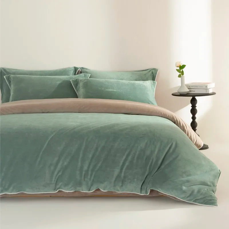 Green velvet reversible bedding set on a bed with a side table in the background.