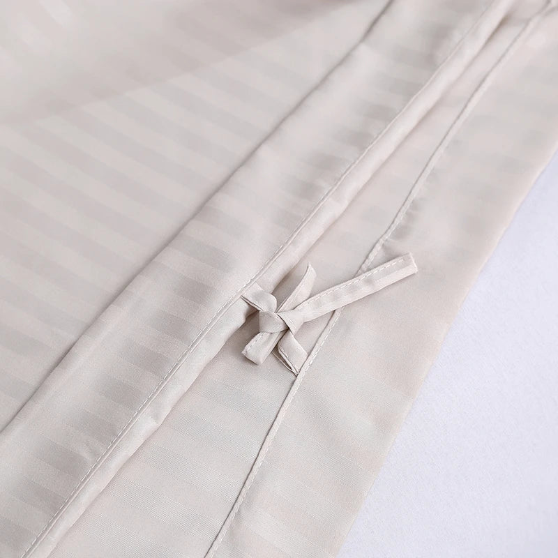 Light gray fabric with a ribbon detail on a white background