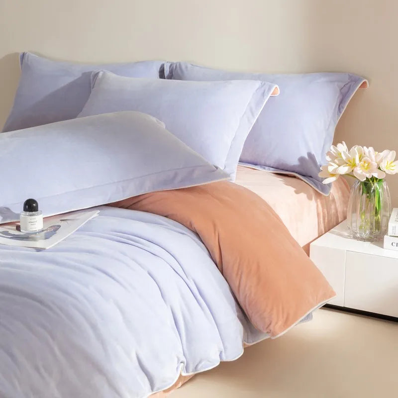 Light purple bedding set with a nightstand and flowers on a neutral background