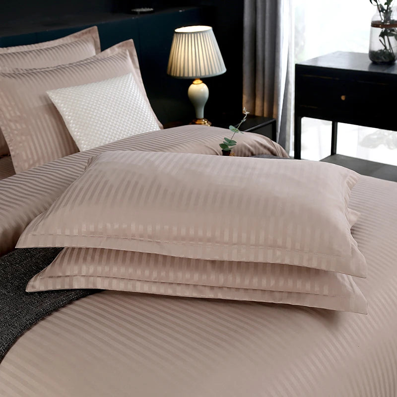 Neatly arranged striped bedding set on a bed. 