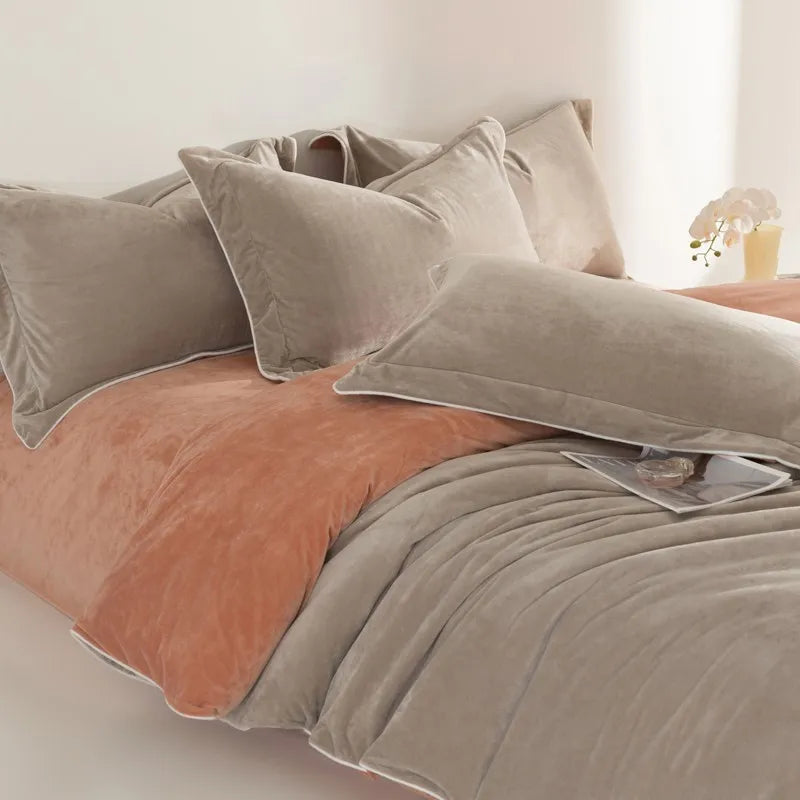 Neatly made bed with beige and brown bedding in a softly lit room.