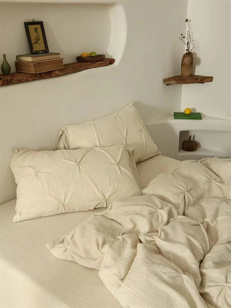 Neatly made bed with beige bedding and pillows in a bedroom setting.