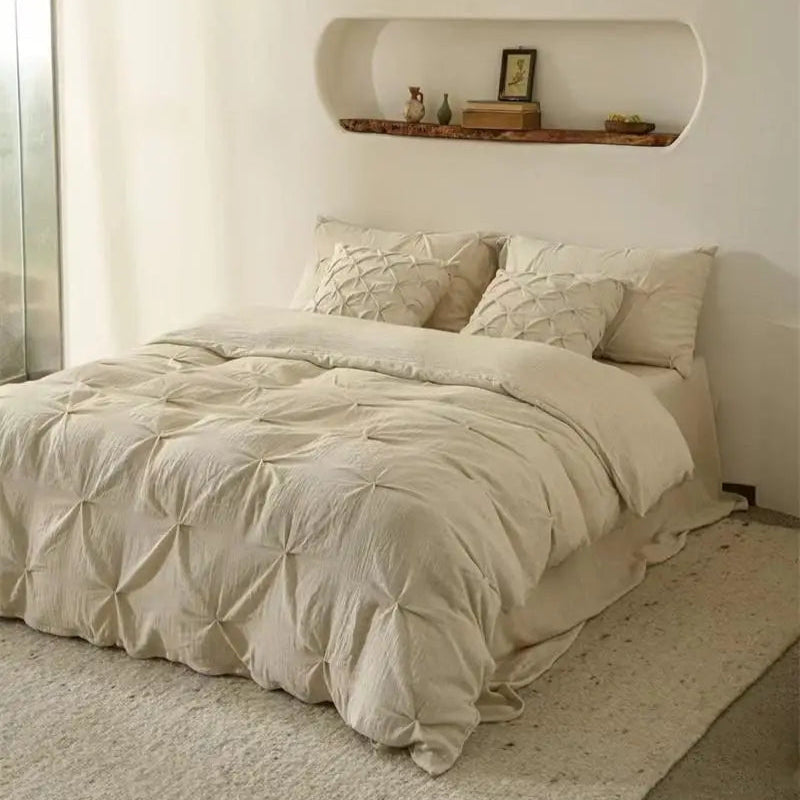 Neatly made bed with beige bedding in a minimalistic bedroom.