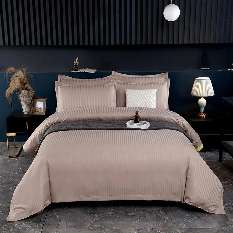 Neatly made bed with beige bedding in a modern bedroom setting.