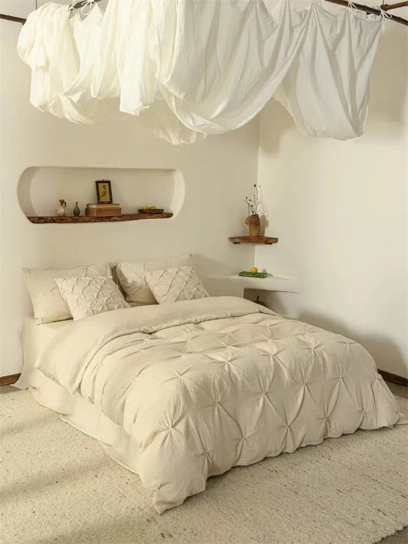 Neatly made bed with beige bedding in a room with minimal decor.