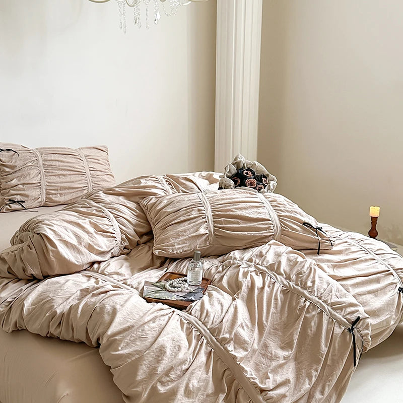 Neatly made bed with beige bedding in a softly lit bedroom.