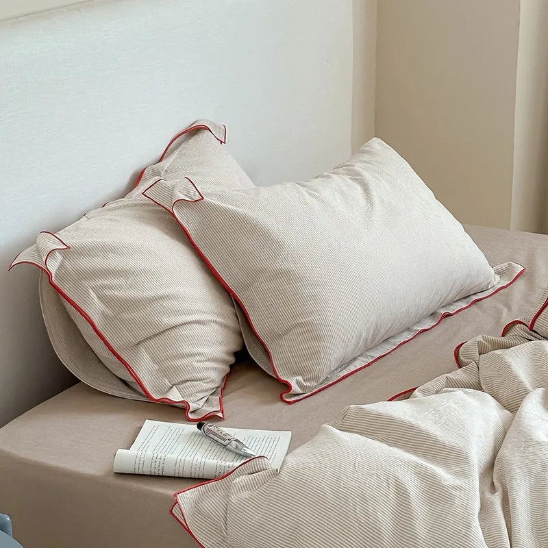 Neatly made bed with beige pillows and bedding