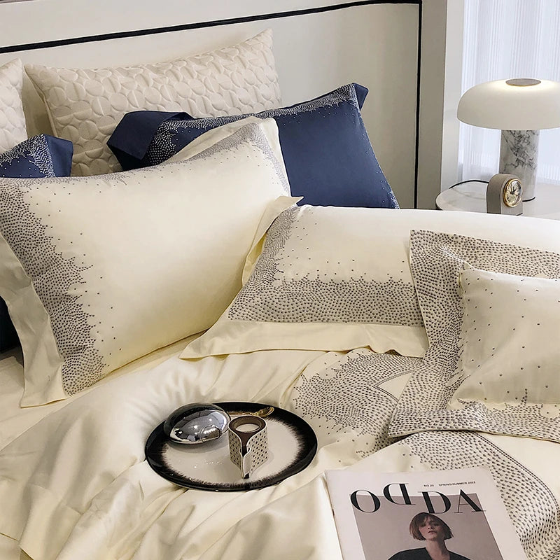 Neatly made bed with decorative pillows and a magazine on a tray.