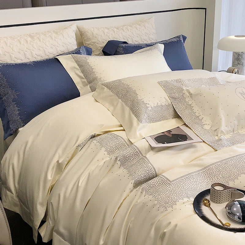 Neatly made bed with decorative pillows and a patterned comforter.