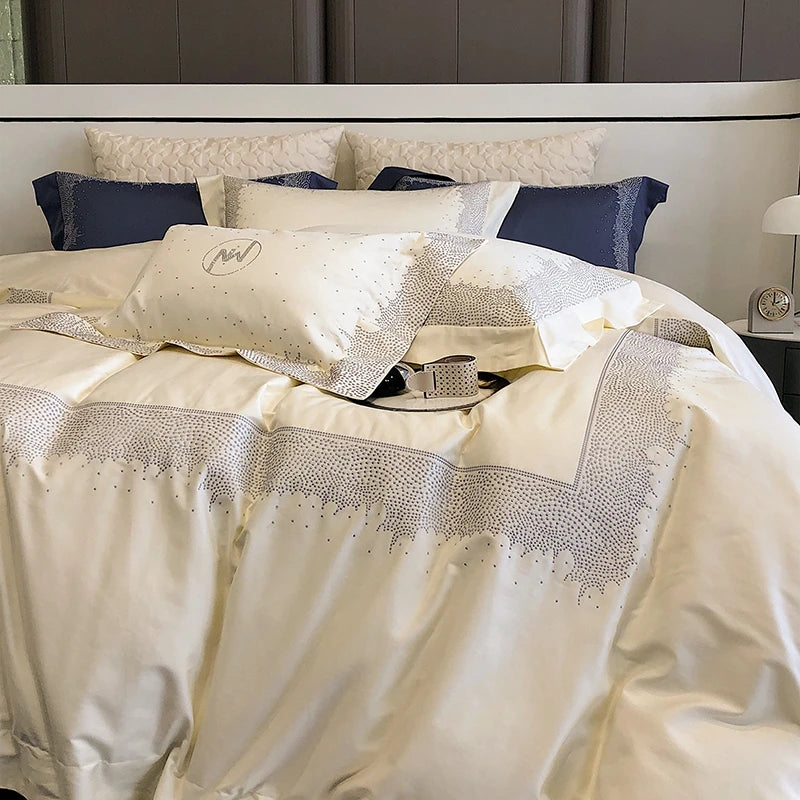 Neatly made bed with decorative pillows and a patterned comforter in a bedroom setting.