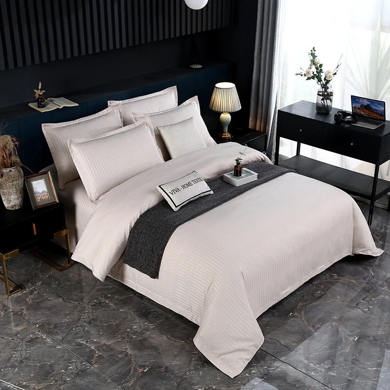 Neatly made bed with off white bedding in a modern bedroom setting.