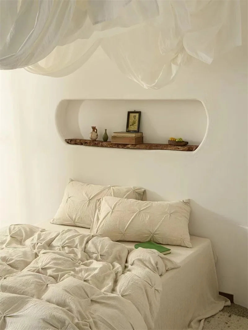 Neatly made bed with pillows and duvet cover beddings at The Happy Ladies