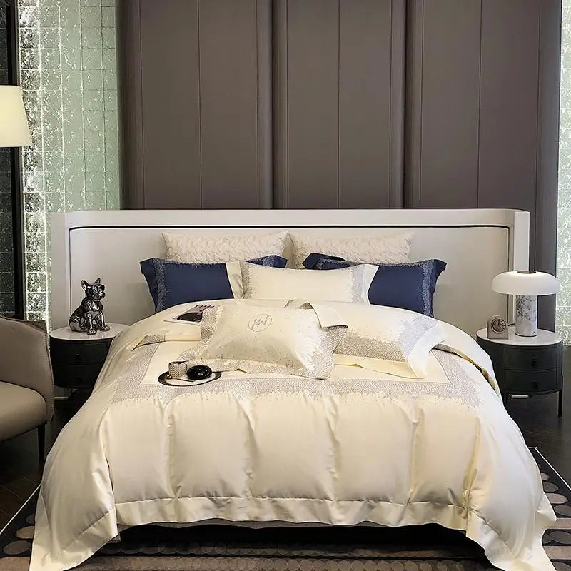 Neatly made bed with white bedding and blue pillows in a modern bedroom setting.
