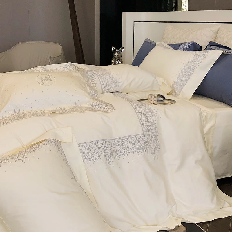 Neatly made bed with white bedding and decorative pillows at the happy ladies