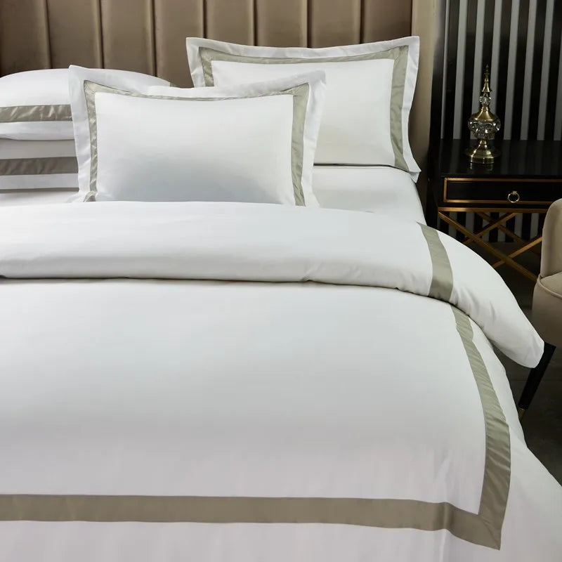 Neatly made bed with white bedding and decorative pillows in a bedroom setting.