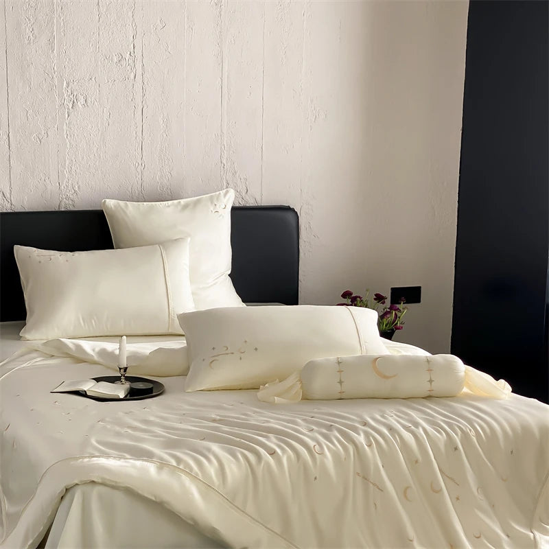 Neatly made bed with white bedding and pillows against a neutral wall.