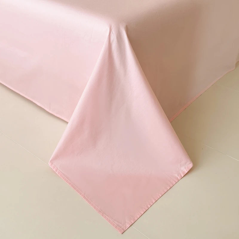Pink flat bedding sheet fabric on a beige background