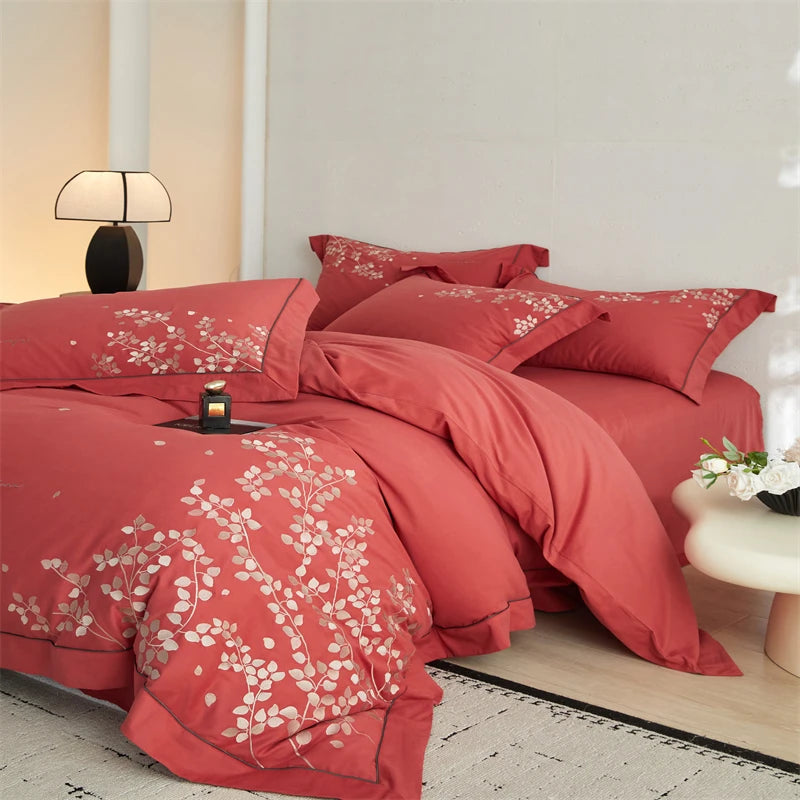 Red floral bedspread on a bed in a bedroom setting
