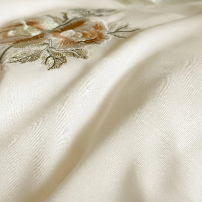 Silky fabric with floral embroidery on a beige background