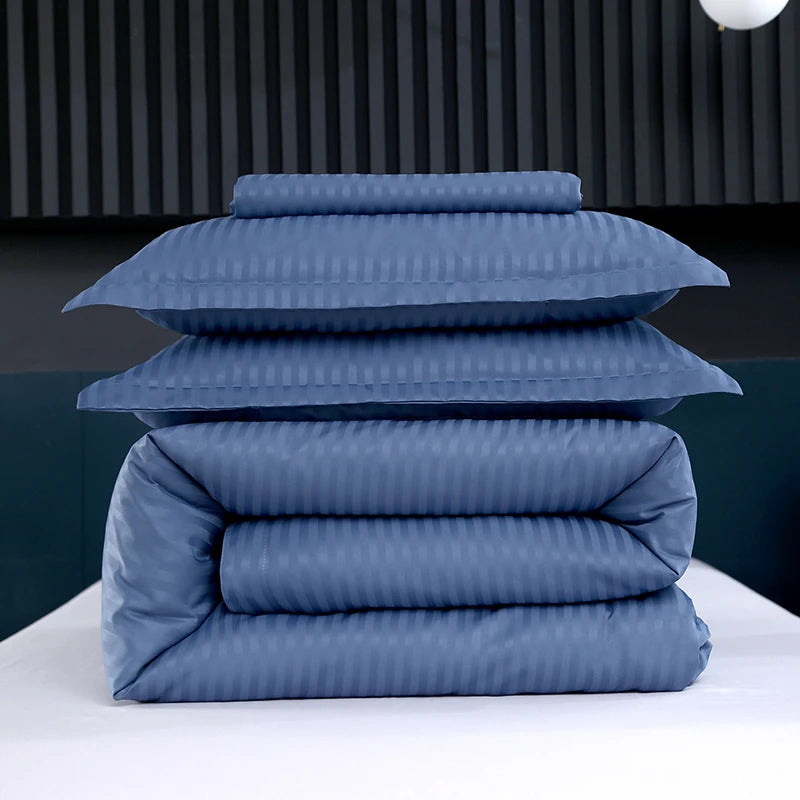 Stack of blue bedding on a white surface with a dark background