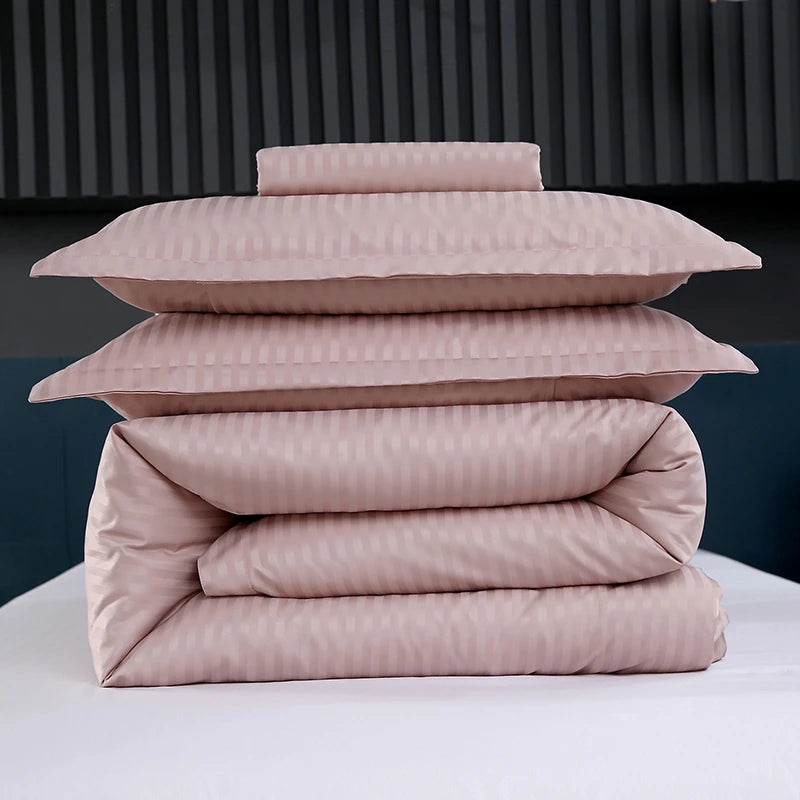 Stack of pink striped bedding on a white surface with a dark background