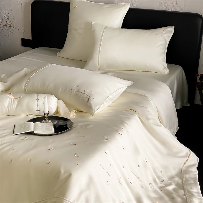 White bedding set with decorative pillows on a bed.