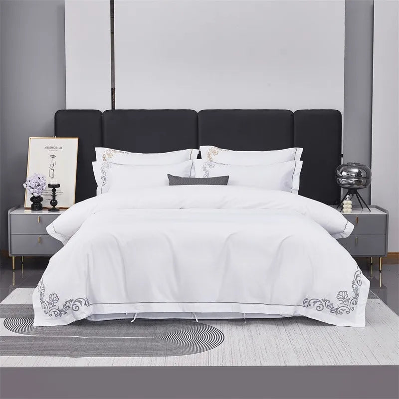 White comforter with floral embroidery on a bed in a modern bedroom setting.
