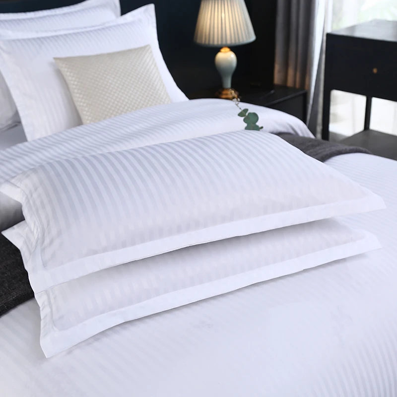White pillows on a bedding set in a bedroom setting