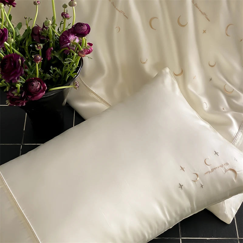 White pillows with embroidered designs and pillowcases