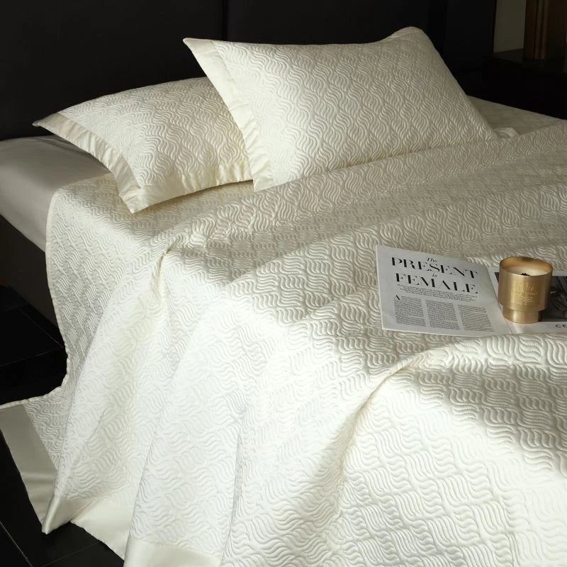 White textured bedspread on a bed.