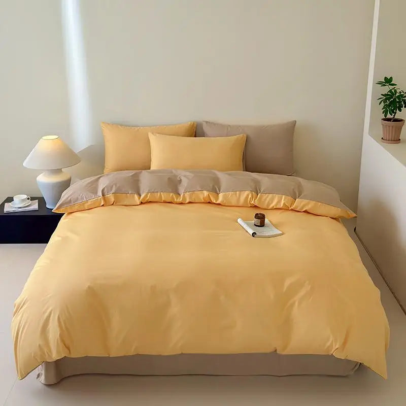 Yellow and beige bedding set on a bed in a minimalistic room.